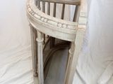 an image of a white wicker chair against a white backdrop