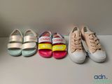 four pairs of children ' s shoes lined up in a row