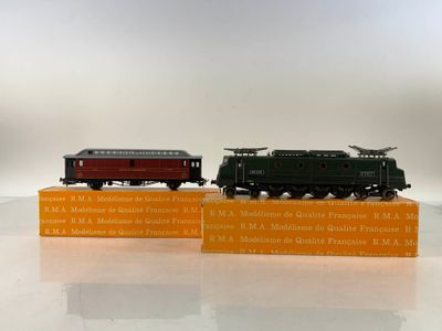 two miniature trains sitting on top of each other on a table