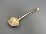 a close up of a spoon on a table with a gray background