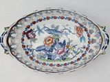 a picture of a bowl with a bird and flowers on it