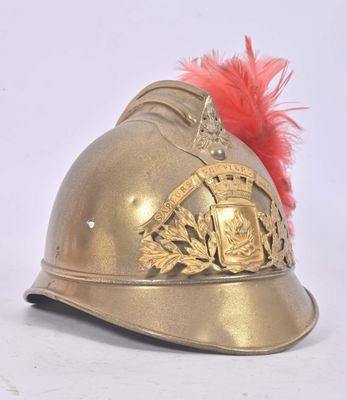 a gold helmet with a red feather on top of it