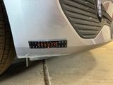a close up of a car with a sticker on it ' s bumper