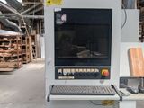 a computer sitting on top of a machine in a warehouse