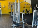 a gym room with a variety of machines in it