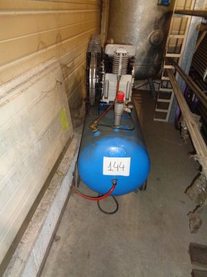 a blue tank sitting next to a blue machine in a room