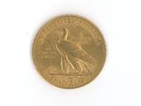 a gold coin with a bird on it on a white surface