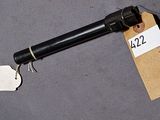 a gun with a tag attached to it sitting on a table