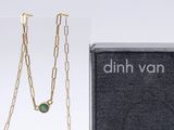 an image of a necklace with a green stone on it and a box