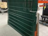 a large green fence in the middle of a warehouse