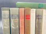 several books are lined up in a row on a table