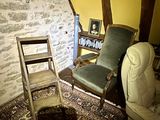 a chair that is next to a chair in a room