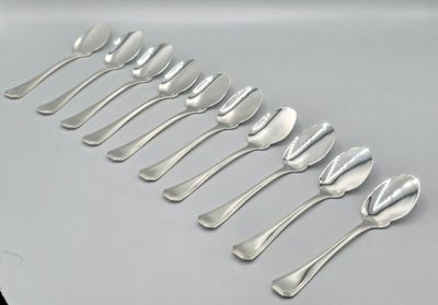 six silver spoons are lined up in a row on a white surface