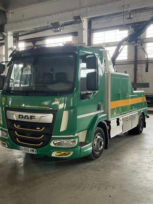 a green truck that is parked inside of a building