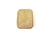 an image of a small gold box with a design on it