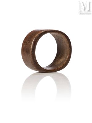 a close up of a wooden ring on a white background