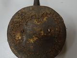 an old metal object that is on a table