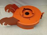 a close up of an orange blower on a white surface