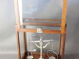 an old wooden display case with a cross inside of it