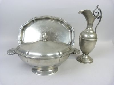 a silver bowl and a silver vase on a white background