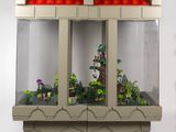 un petit aquarium contenant des plantes, posé sur une surface blanche