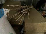 a pile of wood sticks and a bag of cement