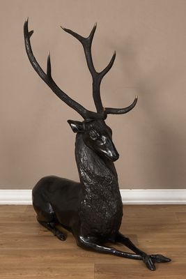 an image of a statue of a deer laying down on the floor