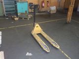 a fork lift in the middle of a warehouse floor