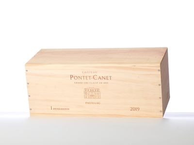 a wooden box that has a bottle of wine in it