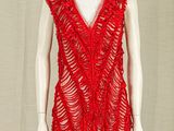 a mannequin with a red top on a stand