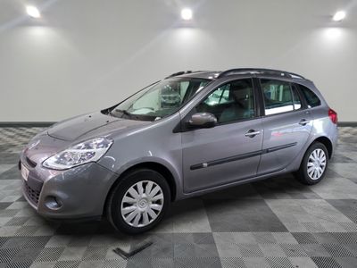 the grey car is parked on a checkered floor in the garage