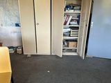 a yellow chair sitting in the middle of a room