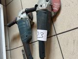 two electric tools that are sitting on a tiled floor