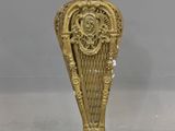 a gold vase that is sitting on a table