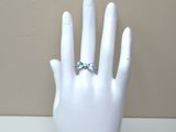 a white mannequin hand with a diamond ring on it