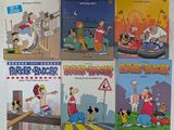 six albums de bandes dessinées mettant en scène divers personnages sont posés sur une surface blanche