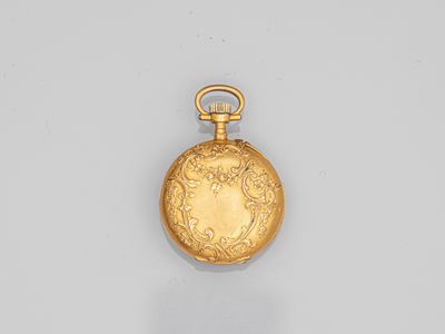 an old gold pocket watch with a chain hanging from it ' s side