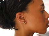 a woman that has a pair of earrings on her ear