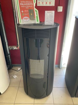 un chauffe-eau noir posé à même le sol dans une pièce