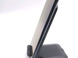 a cell phone on a stand on a white surface