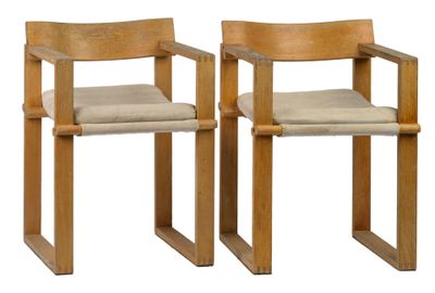 two wooden chairs with beige cushions on them against a white background