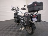 a motorcycle that is parked in a room with a checkered floor