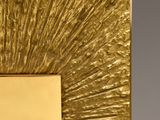 gold metal picture frame with sunbursts in the middle of it