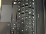 a black laptop with a black keyboard on a wooden table
