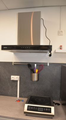a kitchen with a stove and a range hood in it