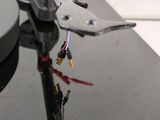a close up of a turntable with a pair of pliers on top of it