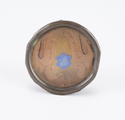 an image of a close up of a ring with a blue flower on it