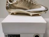 a close up of a pair of gold shoes on a white box
