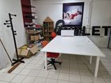 a white table with a red chair in a room