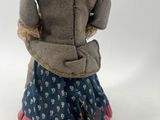 an image of a doll that is sitting on a white surface